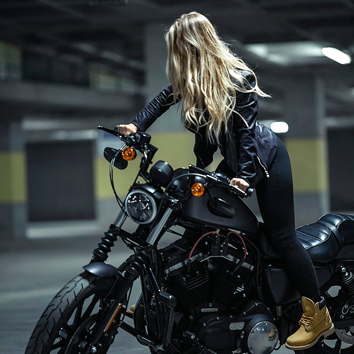 Rider in a black leather jacket on a cruiser motorcycle