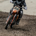 Rider in off-road helmet riding a dirt bike