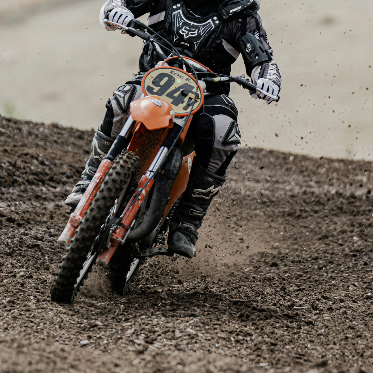 Rider in off-road helmet riding a dirt bike