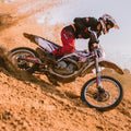 Motocross rider in a red and black off-road suit