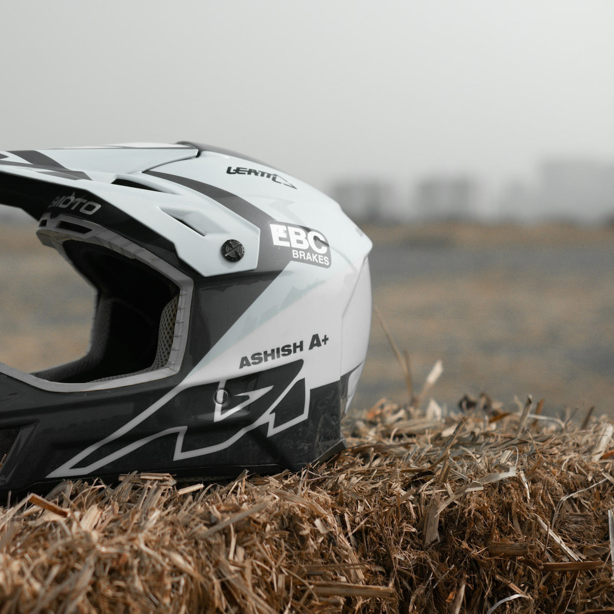 Off-road motocross helmet on dry grass
