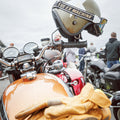 Leather touring gloves resting on a motorcycle
