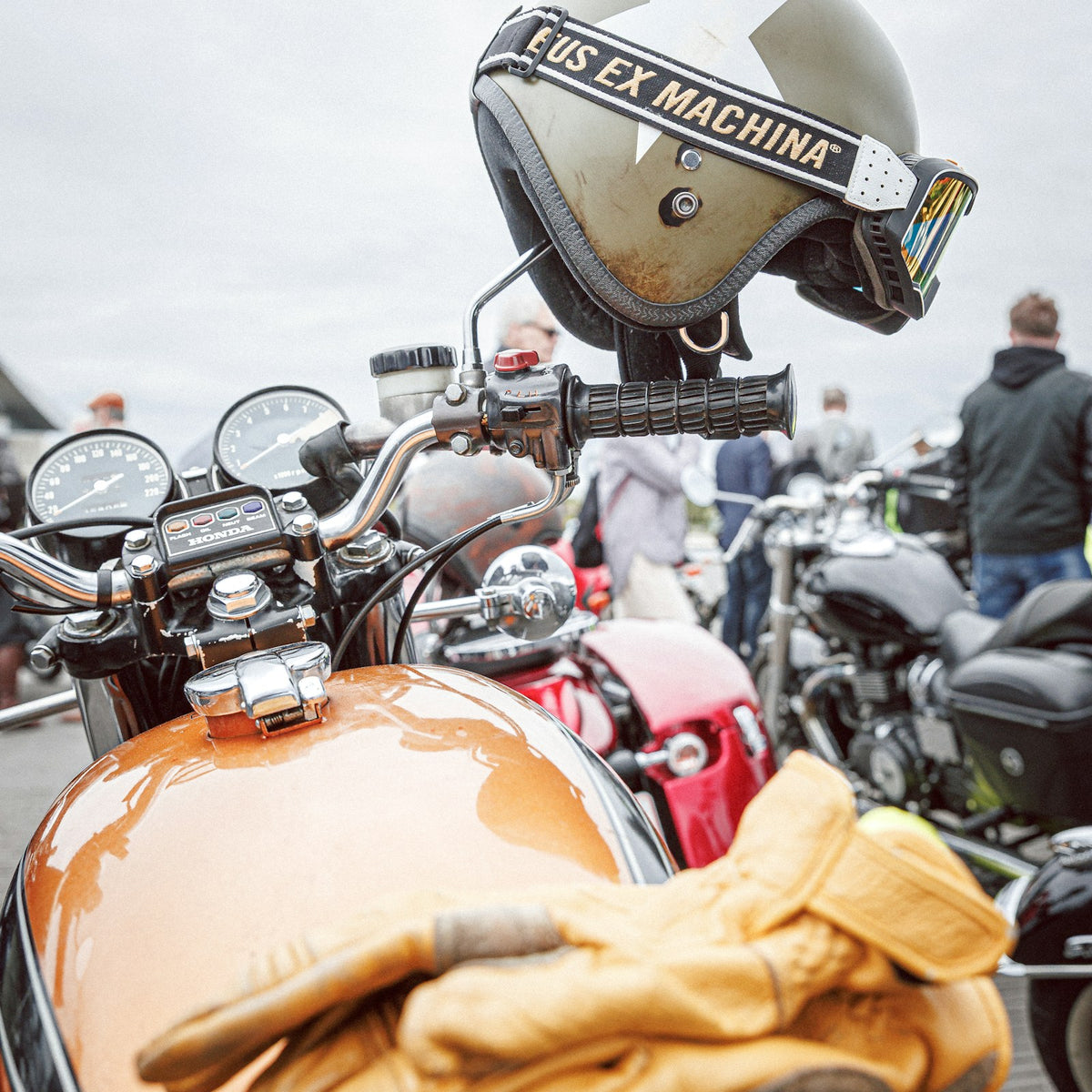 Leather touring gloves resting on a motorcycle