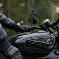 Rider wearing leather touring gloves on a motorcycle