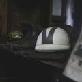 Dark cruiser riding boots and helmet on a shelf